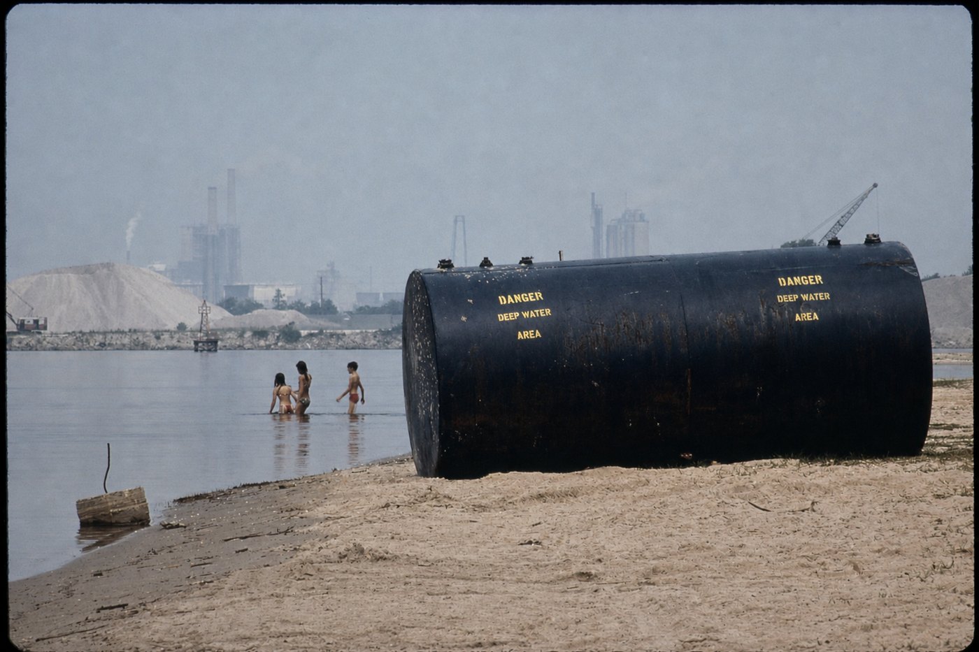 The same photograph with the sky blue and the sand natural again, the warning lettering intact
