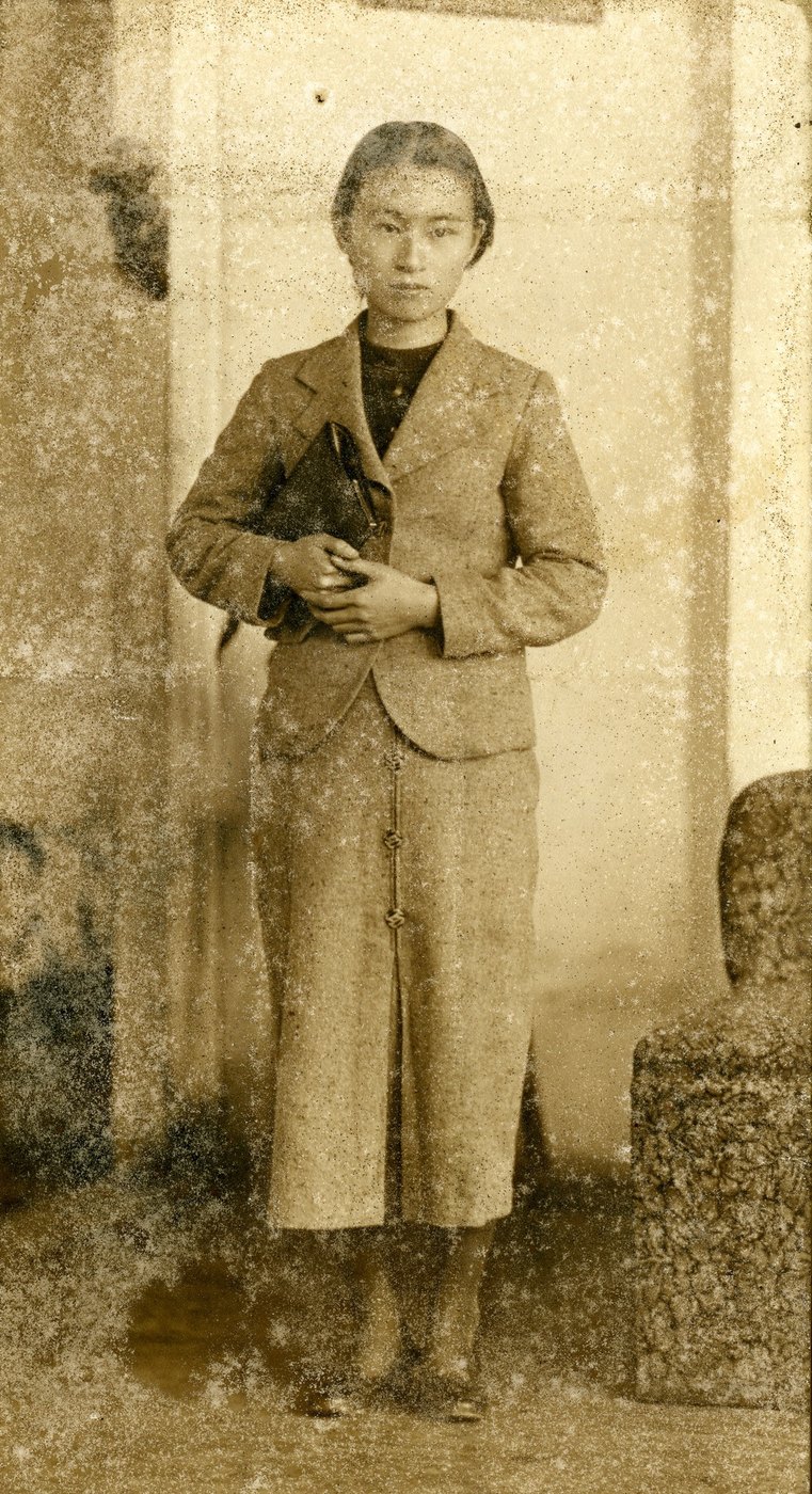 A yellowed black-and-white portrait with almost no contrast left