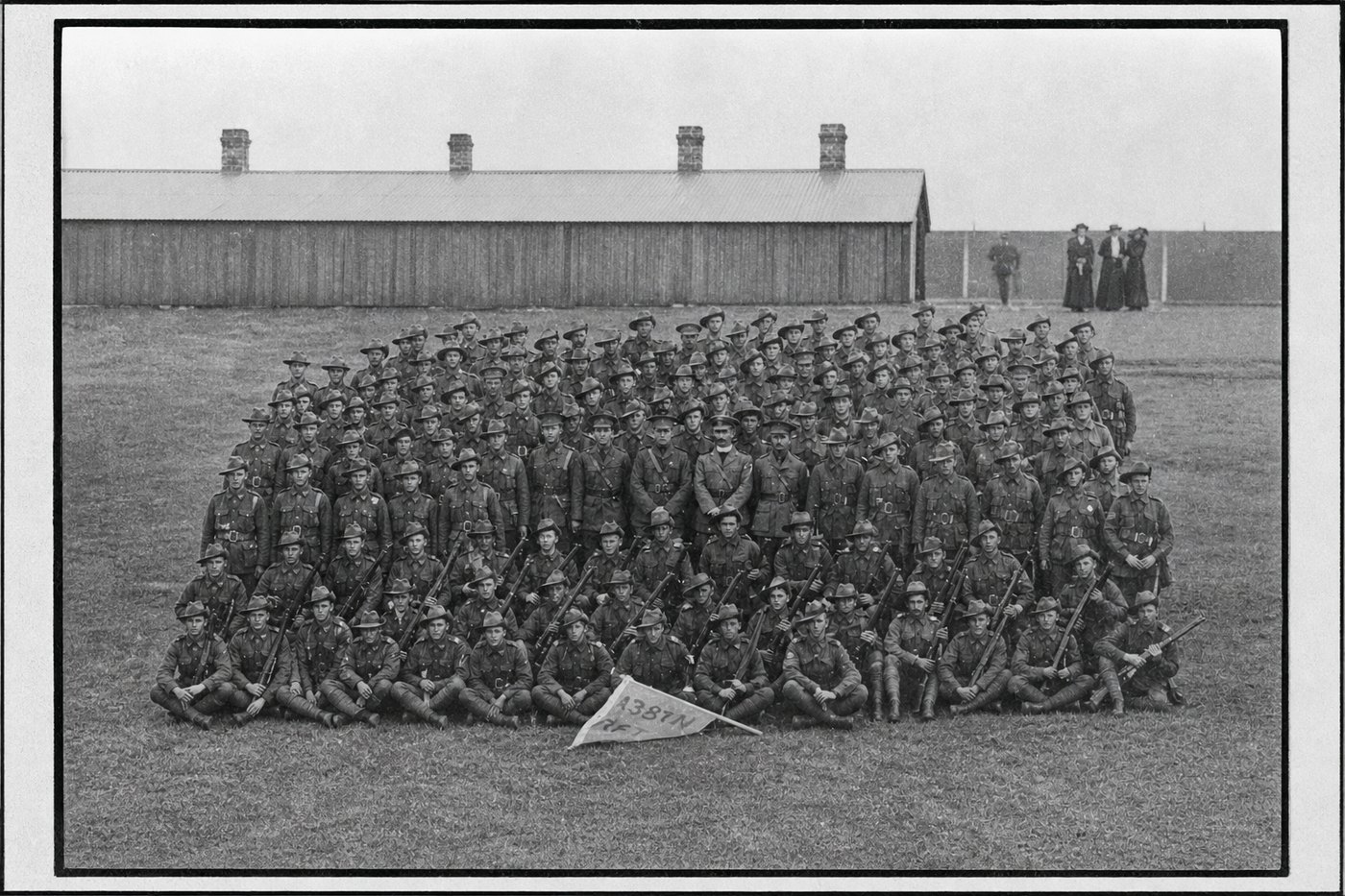 The same photograph returned complete, the destroyed half filled with rows of soldiers the repair supplied