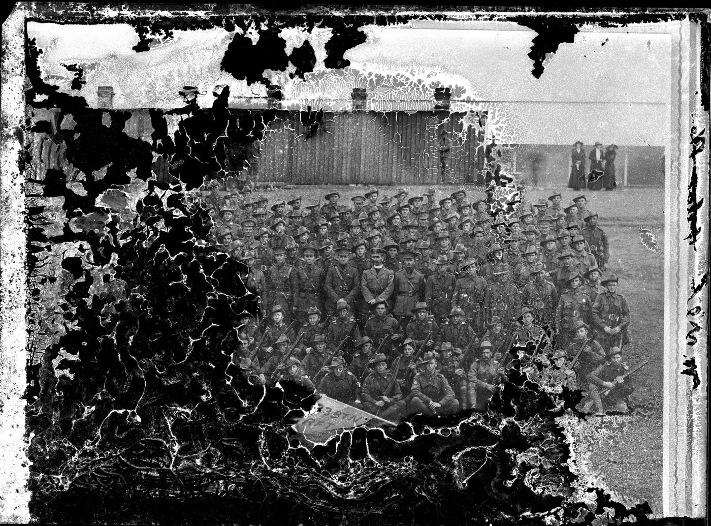 A battalion photograph with the entire left half destroyed by black rot and flaking