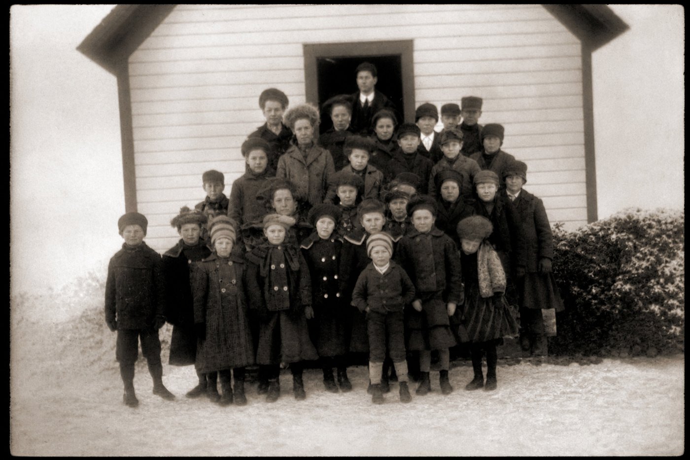 The same photograph returned complete, the destroyed areas filled with children and a bush