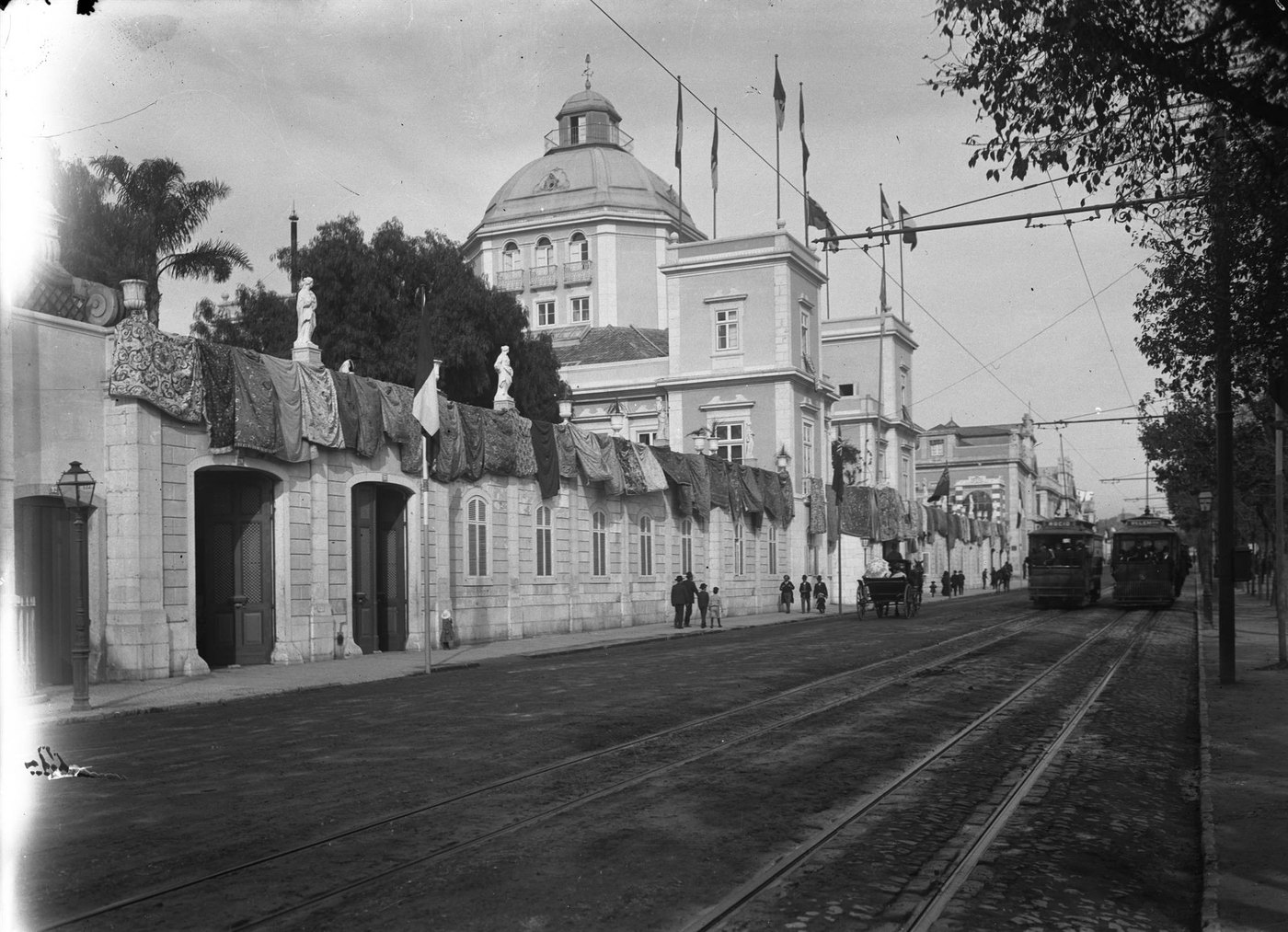 A black-and-white street scene with a domed building and trams, a pale stained band down the left edge
